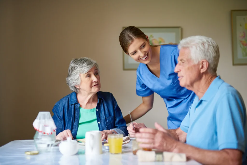Caregiver helping a senior man recover at home after surgery