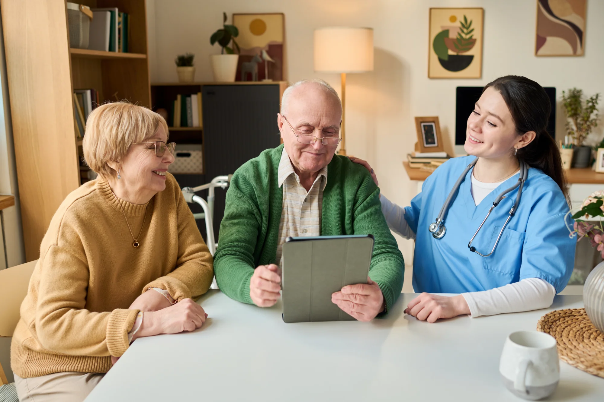Caregiver reviewing a care plan on a tablet with senior clients