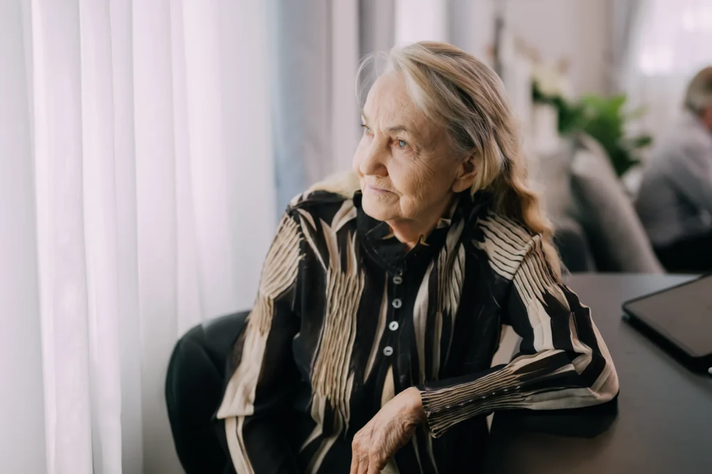 Senior woman relaxing by the window at home