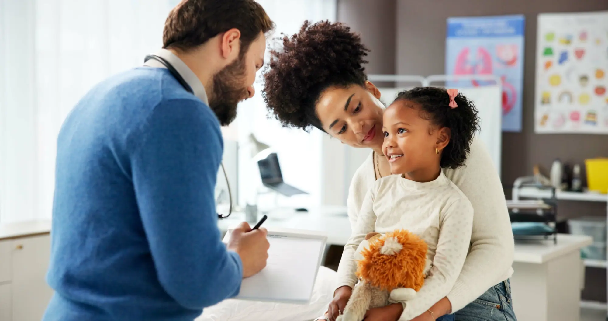 Family with a young child talking with a care professional